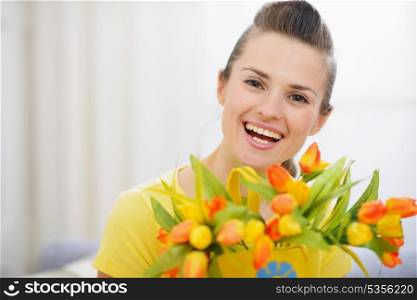Beautiful woman with bouquet of tulips