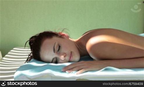 Beautiful woman with closed eyes relaxing outdoor at spa resort