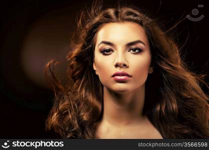 beautiful woman with curly hair in dark