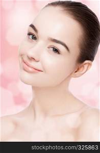 Beautiful woman with cute smile natural makeup spa skin care portrait on pink bokeh background