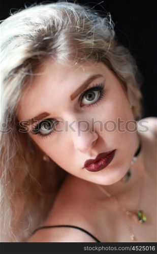 Beautiful woman with dark red lips looking straight to camera