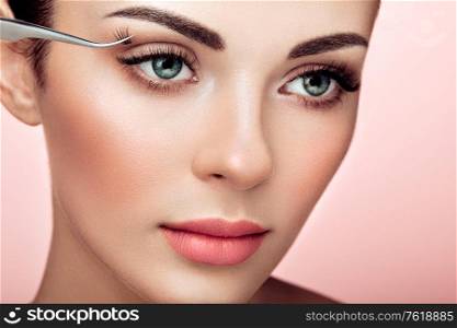Beautiful Woman with Extreme Long False Eyelashes. Eyelash Extensions. Makeup, Cosmetics. Beauty, Skincare. Woman Glues Eyelashes
