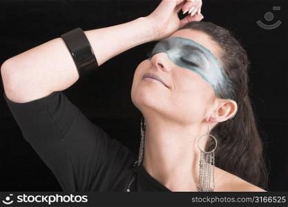 Beautiful woman with extreme make-up on black background
