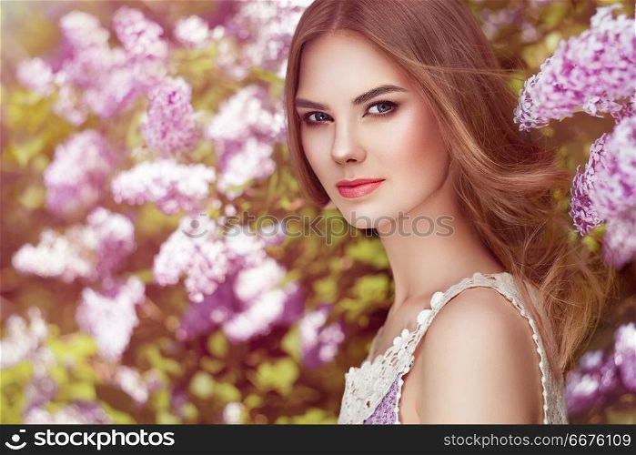 Beautiful woman with flowers of lilac. Beautiful Woman with Flowers of Lilac. Spring Blossom. Sexy Glamour Summer Beautiful Lady with Healthy and Beauty Hair