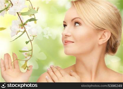 beautiful woman with flowers on twig and butterflies