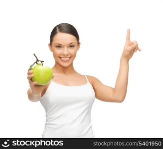 beautiful woman with green apple pointing her finger up.