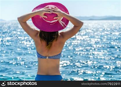 Beautiful woman with hat at the beach