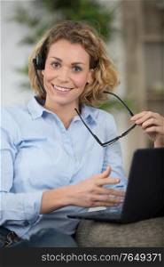 beautiful woman with headset sitting in front of computer