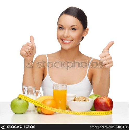 beautiful woman with healthy food showing thumbs up