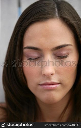 Beautiful woman with her eyes closed