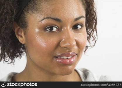 Beautiful woman with her face covered in sweat after working out