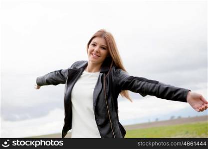 Beautiful woman with leather jacket relaxing in the countryside