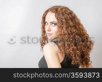 Beautiful woman with long curly hair head and shoulders hairdo concept