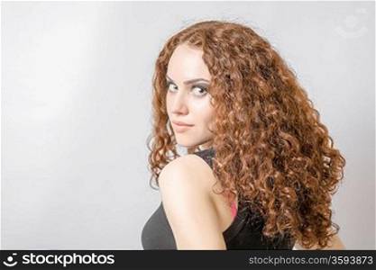 Beautiful woman with long curly hair head and shoulders hairdo concept