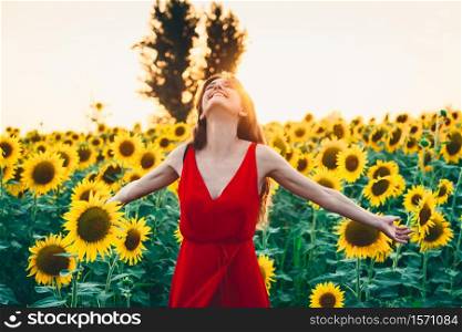 Beautiful woman with long hair in a field of sunflowers. Active, raise.. Beautiful woman with long hair in a field of sunflowers. Active, raise