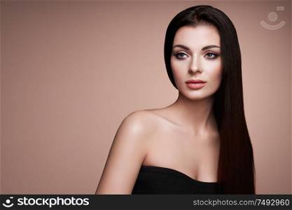 Beautiful Woman with Long Smooth Hair. Girl with Perfect Makeup and Hairstyle. Model Brunette with Perfect Healthy Dark Hair. Fashion Photo