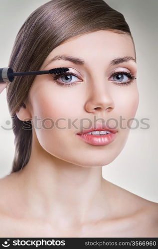 beautiful woman with mascara brush
