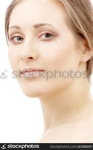 beautiful woman with moisturizing milk drops on face