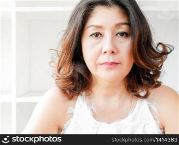 Beautiful woman with no smiling, unhappy against white background.. Beautiful woman with no smiling against white background
