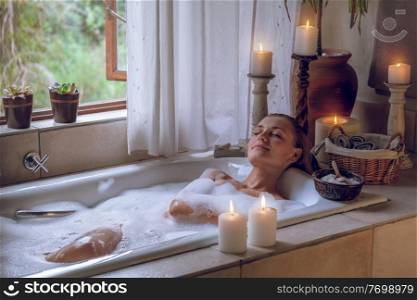Beautiful Woman with Pleasure Lying Down in the Bath With Foam. Enjoying Weekend at Spa Hotel. Pampering Day. 