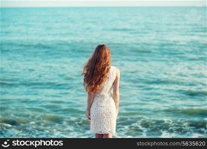 Beautiful woman with red hair at the sea. Fashiob photo