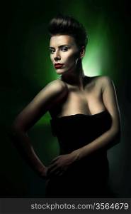 beautiful woman with red lips in dark green light