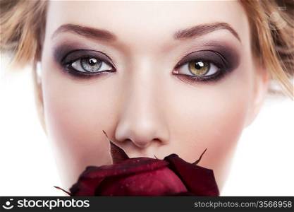 beautiful woman with red rose in mouth on white background
