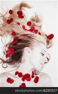 Beautiful woman with rose petals in her hair