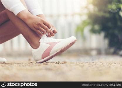 Beautiful woman with running shoes with sunlight in the morning.