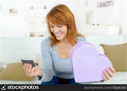 beautiful woman with valentines day gift in heart shaped box