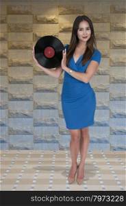 Beautiful woman with vintage record album lps