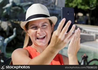 beautiful woman with white hat making a selfie outdoors