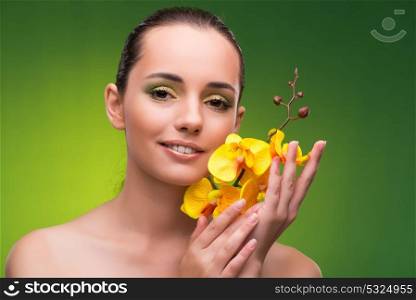 Beautiful woman with yellow orchid flower