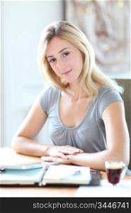 Beautiful woman working at home on agenda