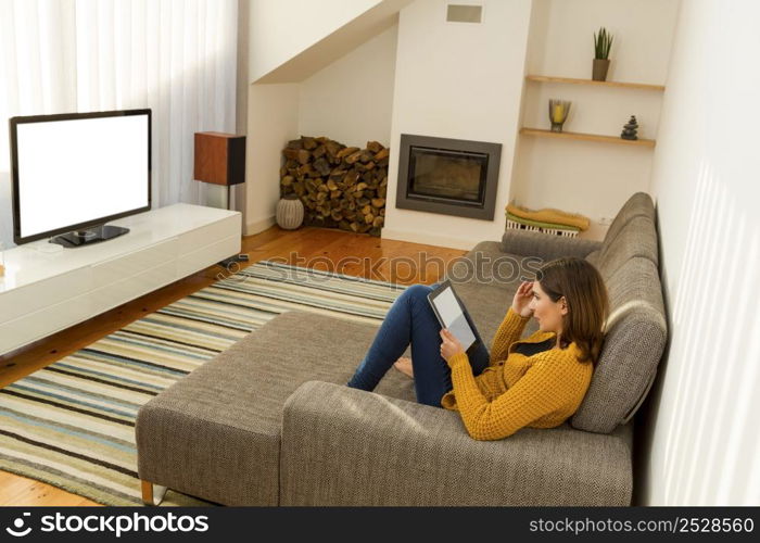 Beautiful woman working at home with a tablet