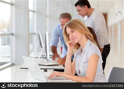 Beautiful woman working in the office on laptop computer