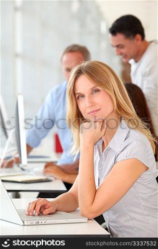 Beautiful woman working in the office on laptop computer