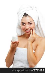 Beautiful women applying moisturizer cosmetic cream on face. Focused on arm with cream. Isolated over white.