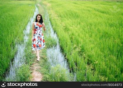 Beautiful women walk happily on the meadow.