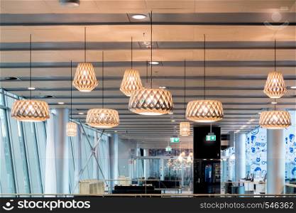 Beautiful wooden geometric modern ceiling lamp interior contemporary decoration. Helsinki, Finland - January 15, 2018: Beautiful wooden geometric modern ceiling lamp interior contemporary decoration