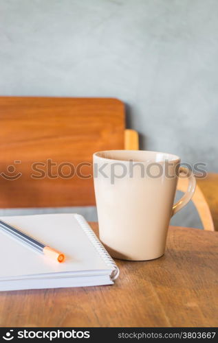 Beautiful wooden work table with cup of coffee, stock photo