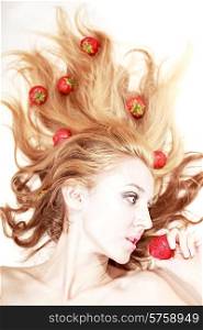 beautiful &#x9;fair woman with silver makeup eating strawberries
