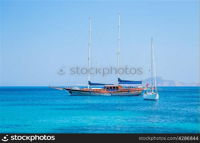 beautiful yachts in the turquoise sea on a background of mountains