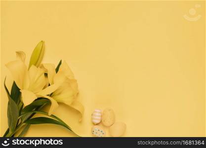 beautiful yellow lily flower with easter eggs yellow backdrop
