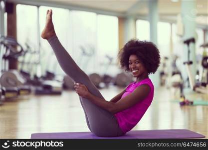 beautiful young african american woman exercise yoga in gym. african american woman exercise yoga in gym