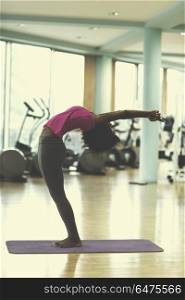 beautiful young african american woman exercise yoga in gym. african american woman exercise yoga in gym