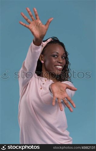 Beautiful young african woman ready for hug on blue background