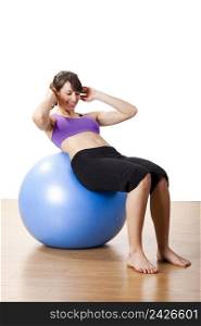 Beautiful young and athletic woman making exercises on a fitness ball