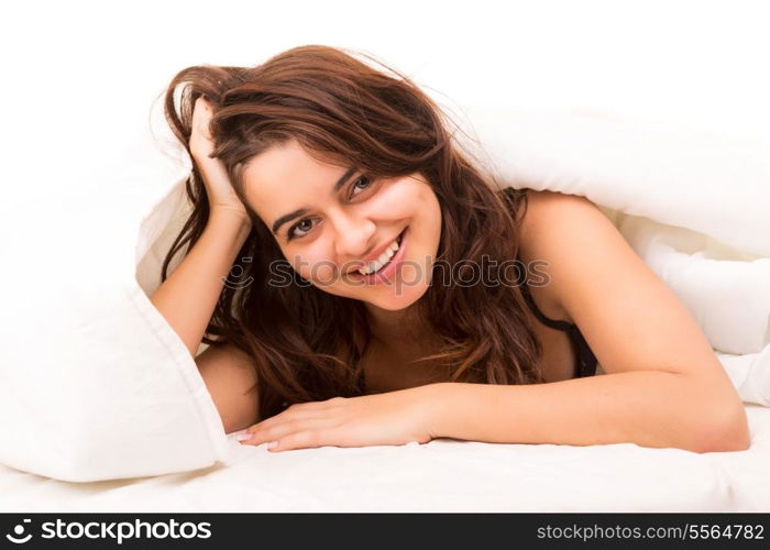 Beautiful young and beautiful woman relaxing in bed