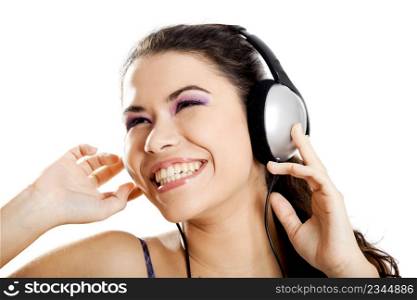 Beautiful young and happy woman listen music with headphones, isolated on white